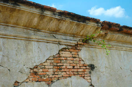Antique and cracked old brick wall texture of the old temple in Thailand.