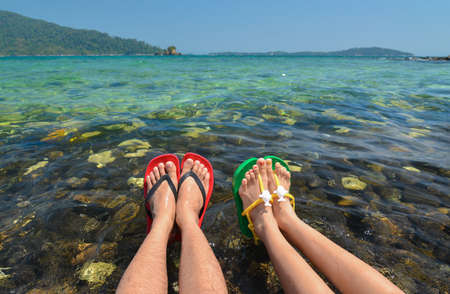 Colorful flipflop sandals on Koh Hin Nham stone beachの写真素材