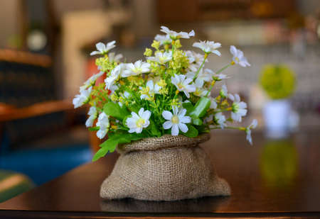 Artificial  white flower in Burlap sackの写真素材