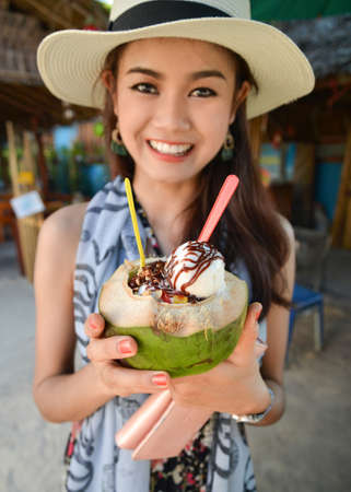 Portrait of young pretty woman holding Coconut Ice Creamの写真素材