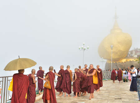 Kyaiktiyo, Mon state, Myanmar- April 24, 2016: Buddhist monks at Kyaiktiyo Pagoda (Golden Rock), One of the most Buddhist worshipful place in Myanmar.のeditorial素材