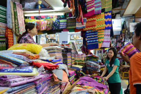 Yangon, Myanmar - April 26, 2016 : People buying traditional burmese clothes in a clothes  shop in Bogyoke marketのeditorial素材