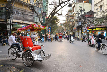 Hanoi, Vietnam - Feb 19, 2107 ; Tricycle (or Cyclo) is waiting for customer at an intersection in Old quarter, Hanoiのeditorial素材
