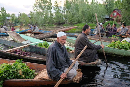 Srinagar, India - 25 April, 2017 :  Kashmiri man  taking their produce to the Dal Lake early morning floating marketのeditorial素材
