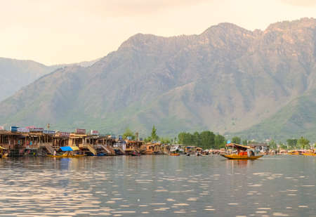 Srinagar,  India - April 25, 2017 : Lifestyle in Dal lake, People using  small boat 'Shikara' for transportation in the early morning at sunriseのeditorial素材