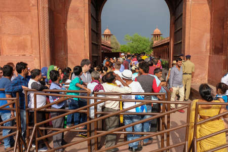 Agra, India - April 29, 2017: Crowd of indian people waiting  in queue to entrance of Taj Mahal west gate, Agra, Indiaのeditorial素材