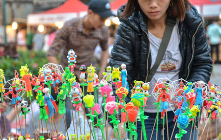 Hanoi, Vietnam - Feb 19, 2107 : Vietnamese traditional toys (called To He) for children from special material of grain and colorful flour for sale on Hanoi old quarter walking street at the weekend.のeditorial素材