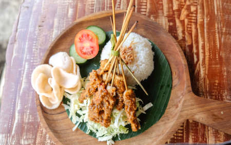 Chicken Sate rice ( Nasi sate) served eggs, prawn crackers and chicken satay and peanut sauce, Indonesian cuisineの写真素材