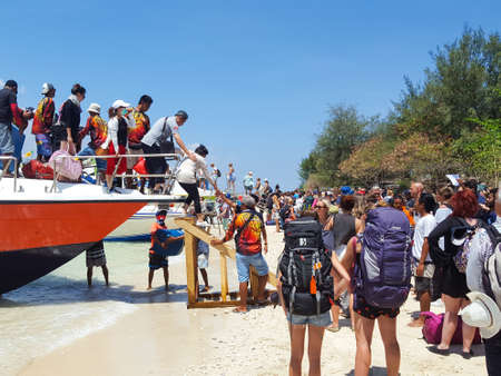 Gili Tranwagan, Lombok/Indonesia  - September 11,2017 : People get down from boat, Transfer boat between Bali and Gili islandのeditorial素材