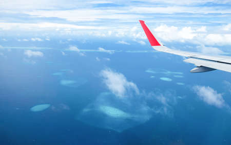 Maldives island atoll, vacation paradise sea, aerial view from airplaneの写真素材