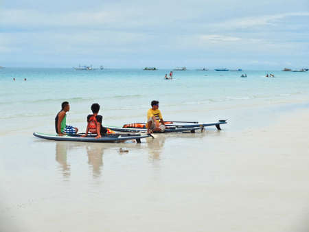 BORACAY, PHILIPPINES - JULY 22, 2015 : Young People playing Paddle Board at Boracay islandのeditorial素材