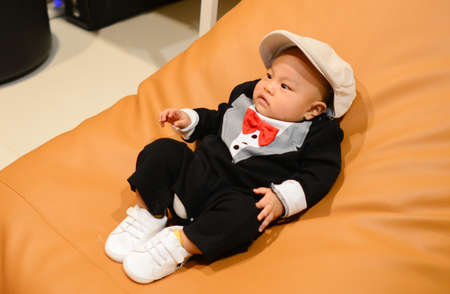 Cute little Asian baby boy wearing Black suite, Handsomeの写真素材