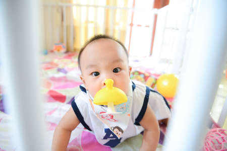 Cute Asian little baby boy chewing teething, Baby first toy