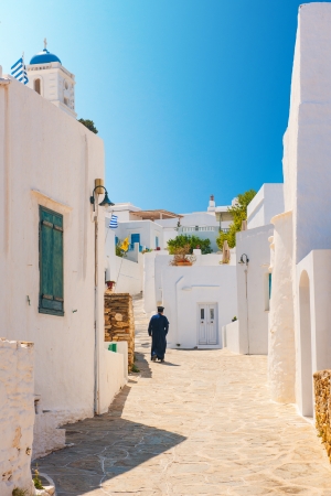 Greek Orthodox priest walking in an alleyway on the island of Sifnosの写真素材