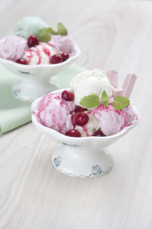 vanilla balls of ice cream with a cranberry fizalisy and red sauce