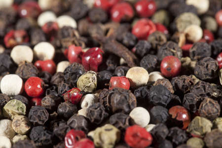 mixture of peppers hot pepper, red pepper, black pepper, white pepper, green pepper, background