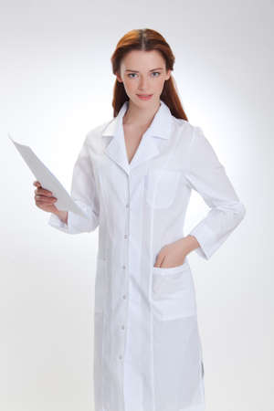 Portrait of a young girl in white  medical lab coatの写真素材