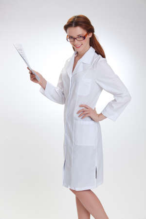 Portrait of a young girl in white  medical lab coatの写真素材