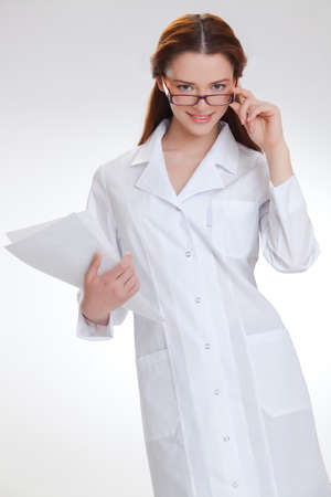 Portrait of a young girl in white  medical lab coatの写真素材