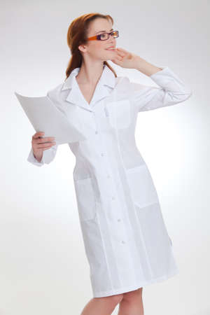 Portrait of a young girl in white  medical lab coatの写真素材