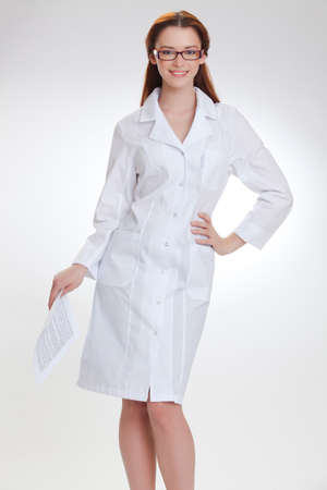 Portrait of a young girl in white  medical lab coatの写真素材