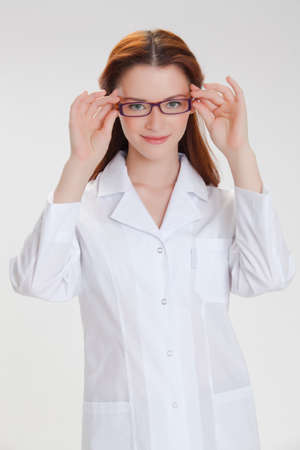Portrait of a young girl in white  medical lab coatの写真素材