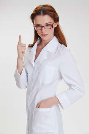 Portrait of a young girl in white  medical lab coatの写真素材