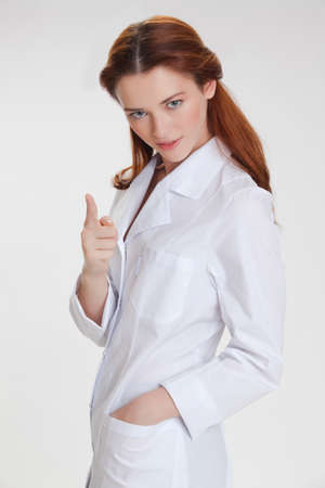 Portrait of a young girl in white  medical lab coatの写真素材