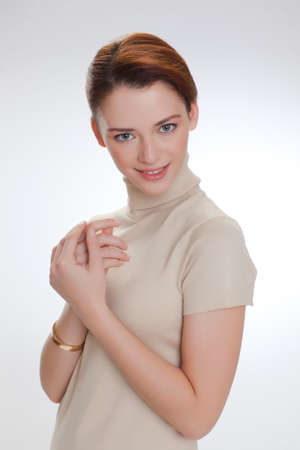 Portrait of a beautiful woman in a beige sweaterの写真素材