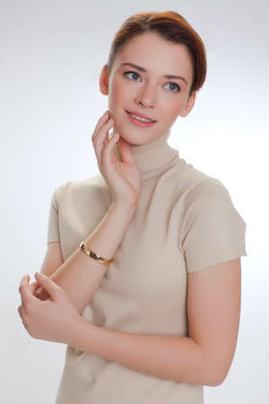 Portrait of a beautiful woman in a beige sweaterの写真素材