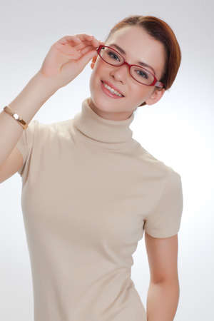 YOUNG BEAUTIFUL GIRL IN GLASSES AND BEIGE JACKETの写真素材