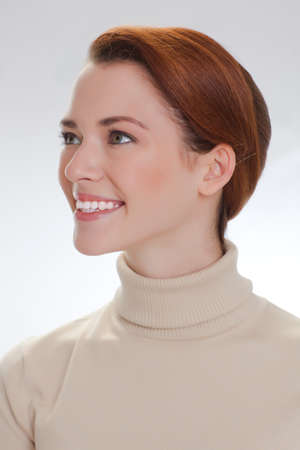 Portrait of a beautiful woman in a beige sweaterの写真素材