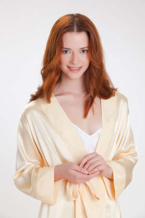 nice girl in beige home dressing gown in the moning with good moodの写真素材