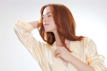 nice girl in beige home dressing gown in the moning with good moodの写真素材