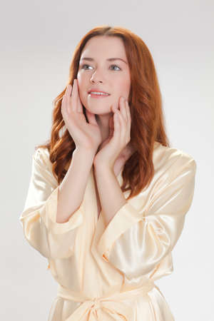 nice girl in beige home dressing gown in the moning with good moodの写真素材