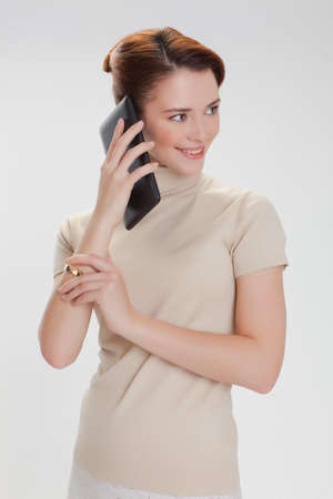 beautiful woman in a beige sweater with tablet computer isolated white backgroundの写真素材