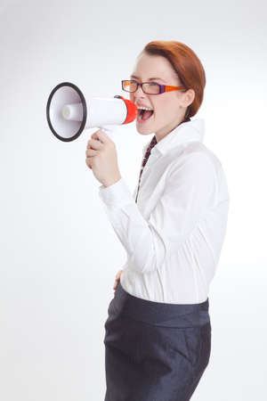business woman is screaming to her associate with megafon  isolated white backgroundの写真素材