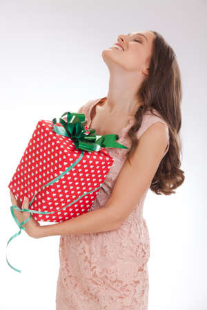 portrait of a young woman in a pink dress  happy dear giftの写真素材