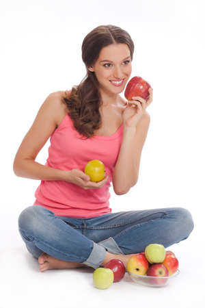 pretty excited  happy smileyoung woman holding glass of orange juice in hand over white backgroundの写真素材