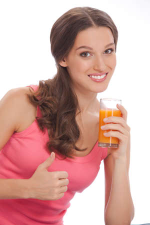 pretty excited  happy smileyoung woman holding glass of orange juice in hand over white backgroundの写真素材