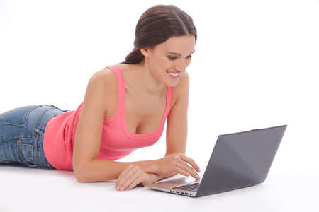Beautiful young woman with laptop  on white backgraundの写真素材
