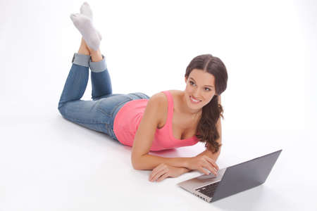 Beautiful young woman with laptop  on white backgraundの写真素材