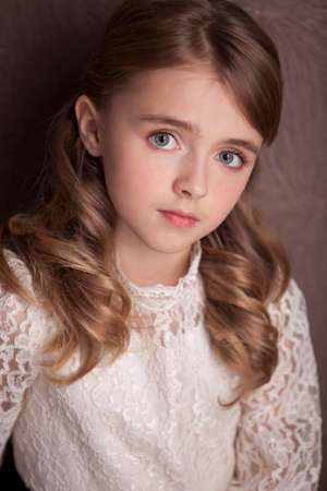 Style teen girl with backpack standing near brown wall.の写真素材