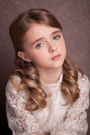 Style teen girl with backpack standing near brown wall.の写真素材