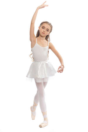 beautiful teen girl in white clothes  ballet pose with long hair isolated on white backgroundの写真素材