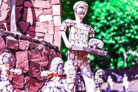 STATUE OF A BOY MADE UP WITH WASTE PLATES AND CUPS SERVING FOOD ON A TRAY, CREATIVITY , ART WORKの写真素材