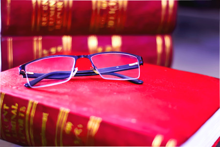 READING GLASS ON RED LAW BOOKSの写真素材