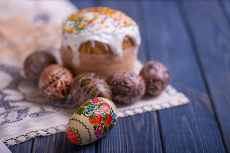 traditional easter cake kulich Ukrainian Russian with colored eggs on blue wooden backgroundの写真素材
