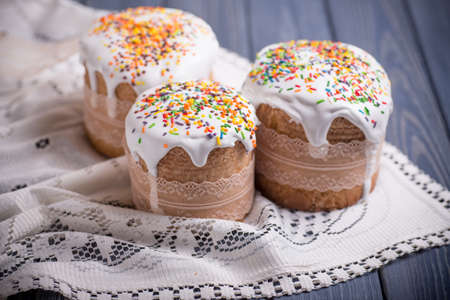 traditional easter cake kulich Ukrainian Russian with colored eggs on blue wooden background