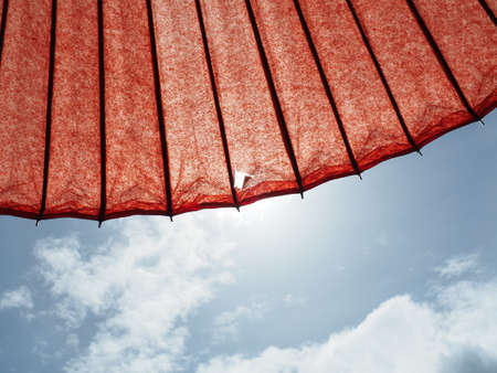 Blue Sky with a red parasolの写真素材